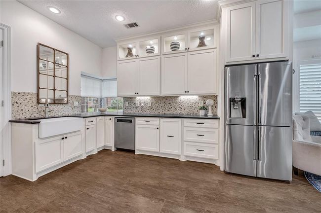 Notice the huge apron farm sink. Floor to ceiling cabinets offer plentiful storage space. | Image 8