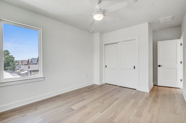 Unfurnished bedroom featuring light wood-style flooring, a closet, baseboards, and a ceiling fan | Image 20
