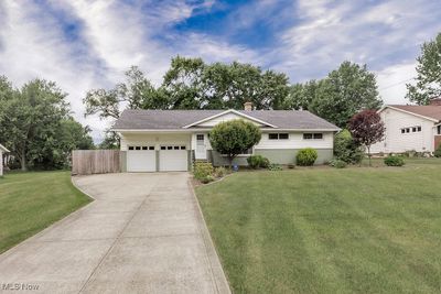 Attached two car garage with additional parking in the driveway. | Image 2