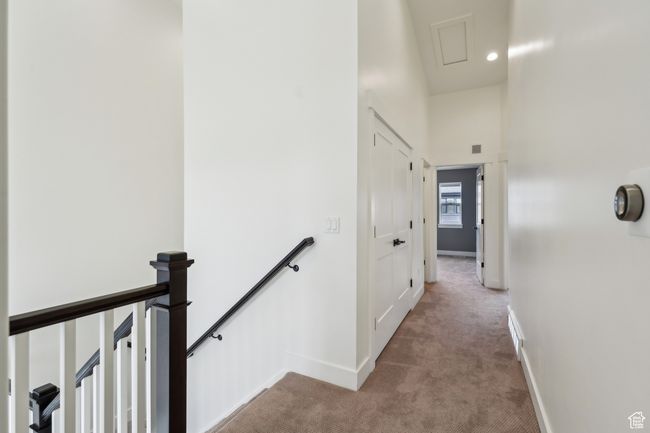 Hallway featuring baseboards, an upstairs landing, and carpet | Image 33