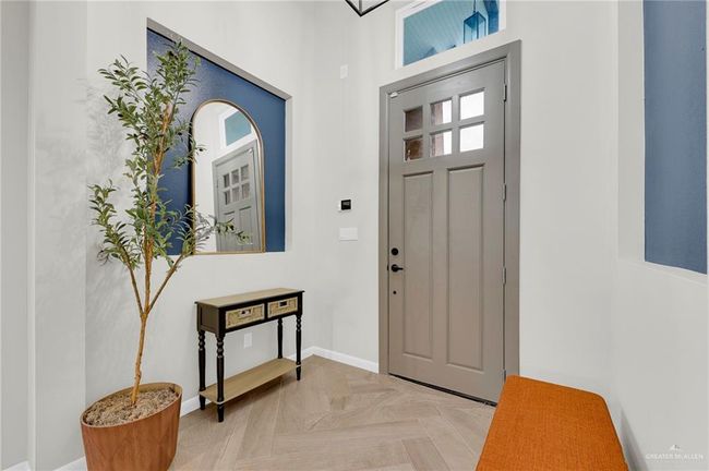 Doorway to outside featuring a chandelier and baseboards | Image 5