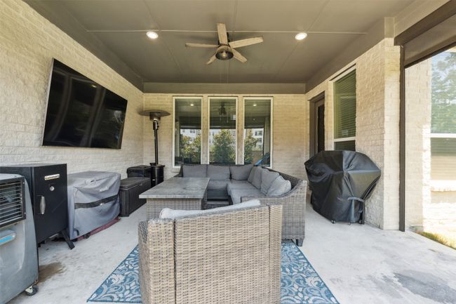 View of patio / terrace with an outdoor living space, area for grilling, and a ceiling fan | Image 33