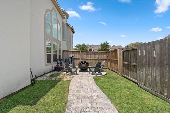 Outdoor Fire pit space along the side of the home. | Image 40
