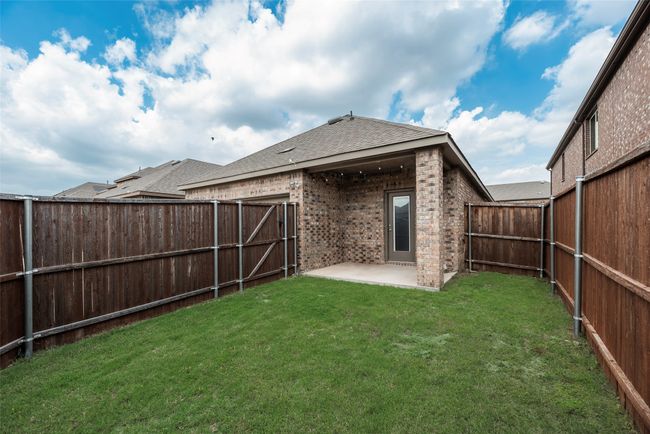 Rear view of property with a patio, brick siding, and a shingled roof | Image 34