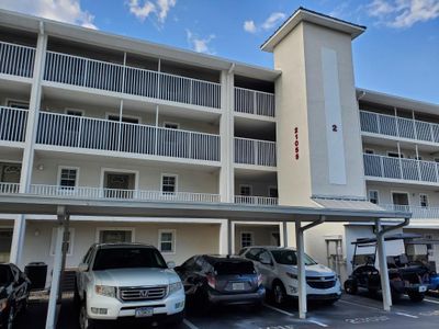 Parking space for condo is to the right of the elevator | Image 1