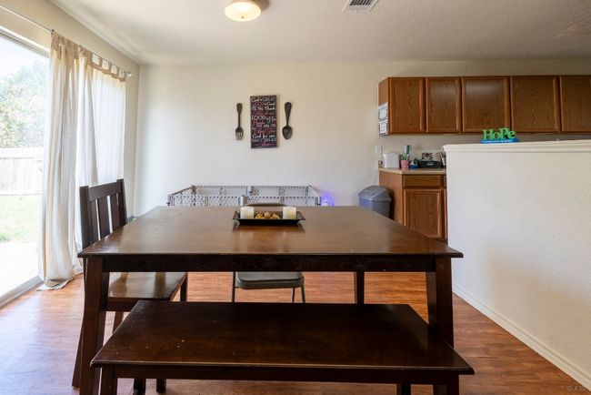 Dining room featuring wood finished floors and baseboards | Image 7