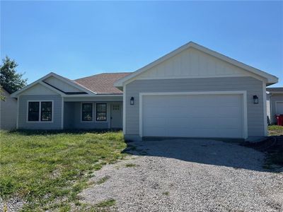 Single story home with a front yard and a garage | Image 1