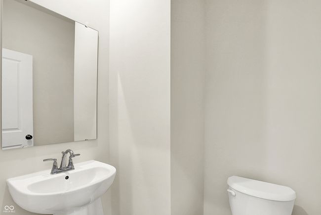 half bathroom featuring toilet and a sink | Image 18