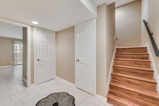 Stairs featuring baseboards, tile patterned flooring, and recessed lighting | Image 4