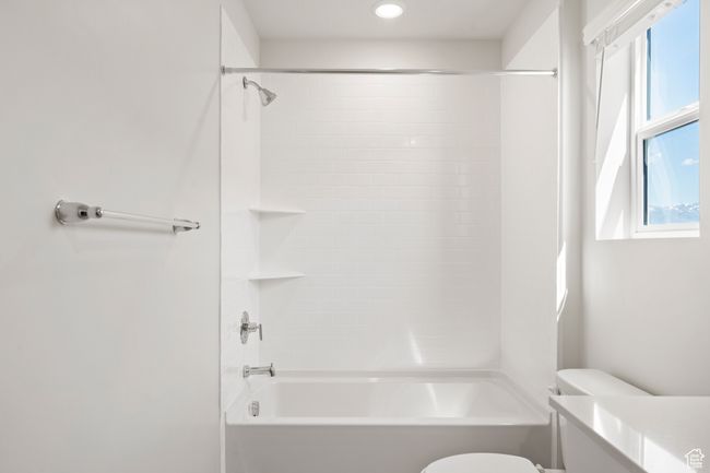 Bathroom with healthy amount of natural light, toilet, and bathtub / shower combination | Image 25