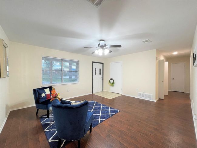 Sitting room featuring hardwood / wood-style flooring and a ceiling fan | Image 8