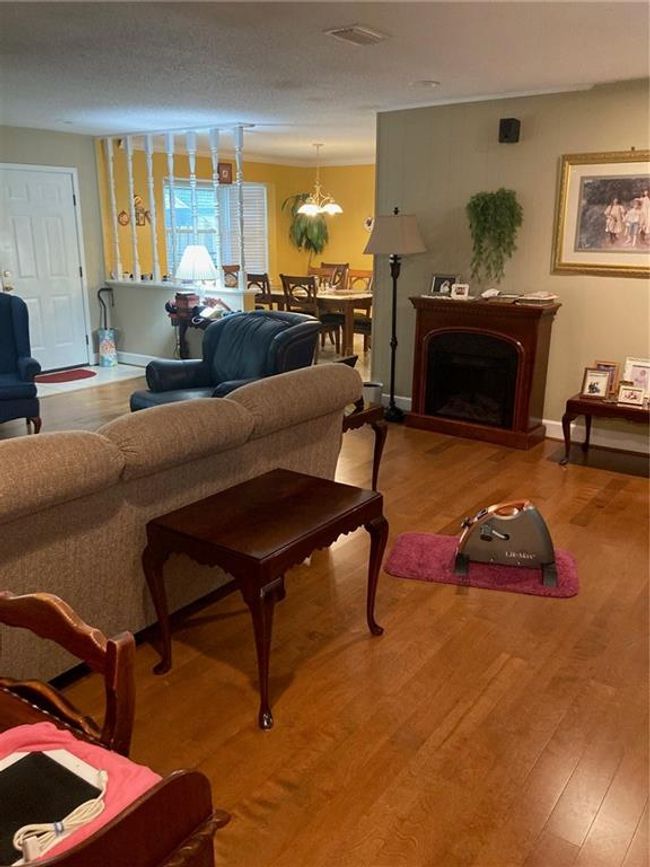 Living room featuring wood-type flooring and a textured ceiling | Image 11