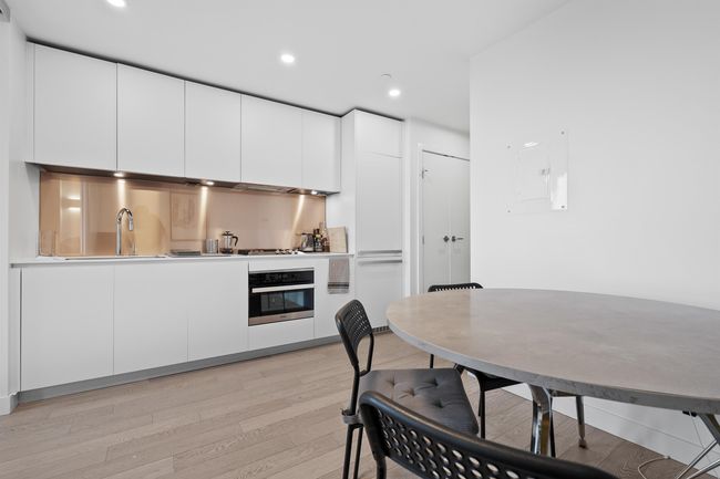 Kitchen featuring stainless steel oven, light wood-style floors, white cabinets, recessed lighting, and stovetop | Image 10