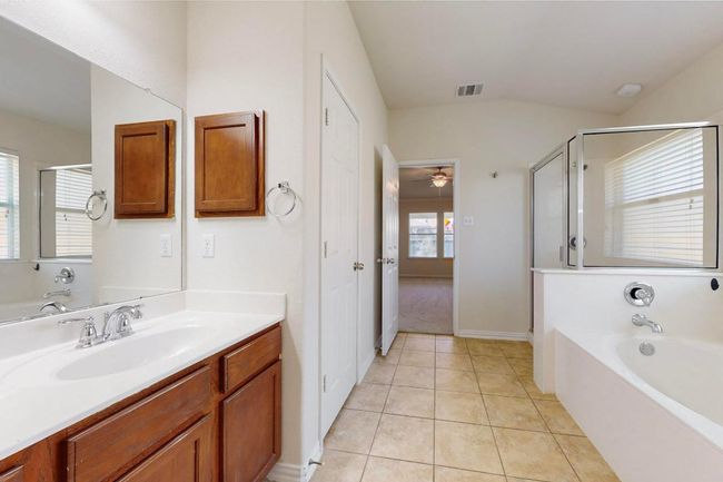 Good sized bathroom with walk in closet and separate water closet. Freshly painted and hard tile flooring for easy clean up. | Image 12