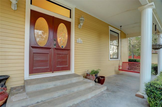 THE WIDE STATELY COLUMNED FRONT PORCH ALLOWS GUESTS & FAMILY TO RELAX TOGETHER & ENJOY THE BEAUTIFUL FRONT YARD. | Image 4