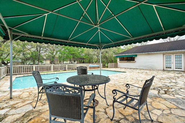 View of swimming pool and pool house with full kitchen | Image 26