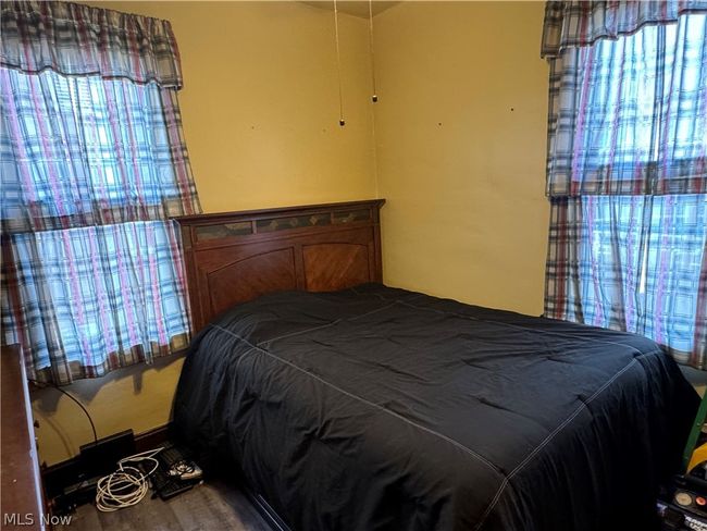 Bedroom with wood-type flooring | Image 13