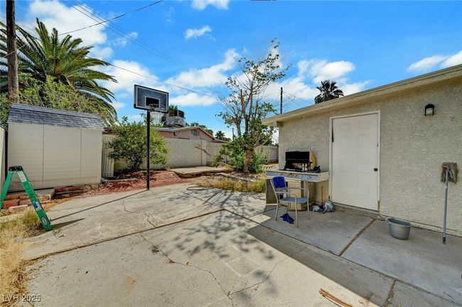 Fenced backyard featuring a patio and a shed | Image 36