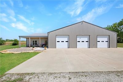 Garage featuring a yard | Image 1