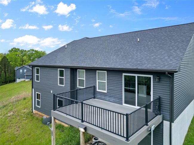 Back of property featuring a shingled roof, a wooden deck, and a yard | Image 48