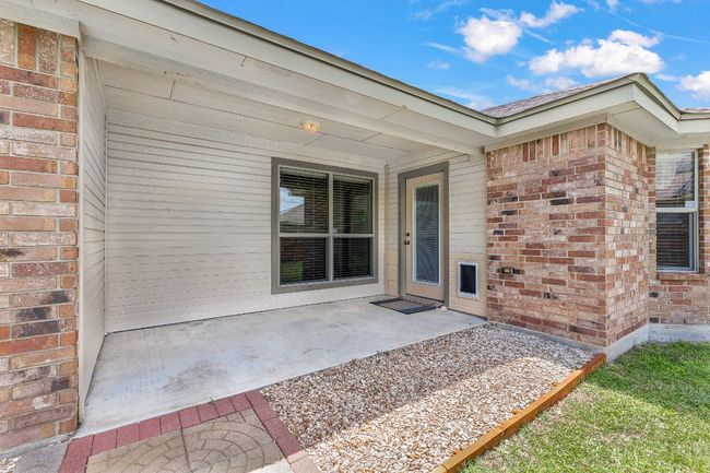 Entrance to property featuring brick siding and a patio area | Image 32