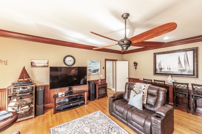 The den has extra bar seating with granite countertops. | Image 38
