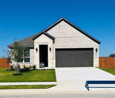 Our beautiful Kendall floor plan comes with a long driveway, a cedar garage door, and lush front yard landscaping. | Image 1