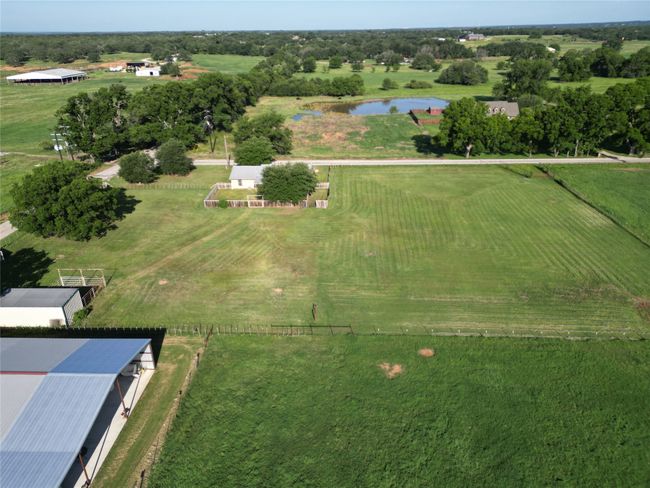 Aerial view of property's location with a large body of water and rural landscape | Image 28