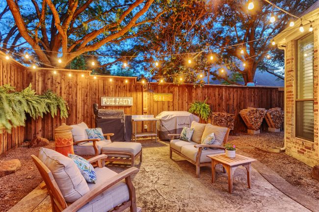 Fenced backyard with area for grilling, outdoor lounge area, and a patio area | Image 31