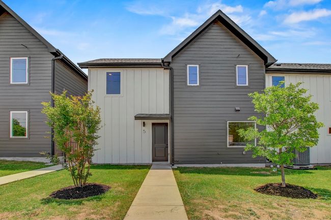 View of front facade with board and batten siding and a front yard | Image 31