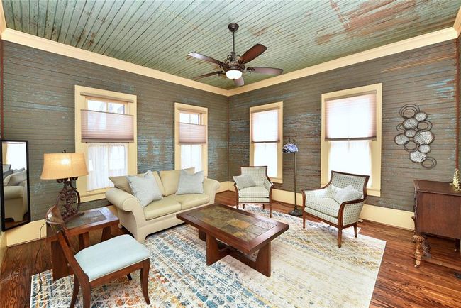 This is the formal living room in the Main home with original shiplap walls and ceilings. The patina look on the walls and ceiling are original. The owner has added top down bottom up shades for perfect lighting. | Image 4