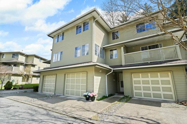 View of front of home featuring a garage, driveway, and a balcony | Image 5