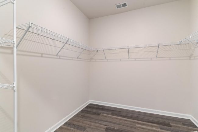 Walk in closet with dark wood-type flooring | Image 17