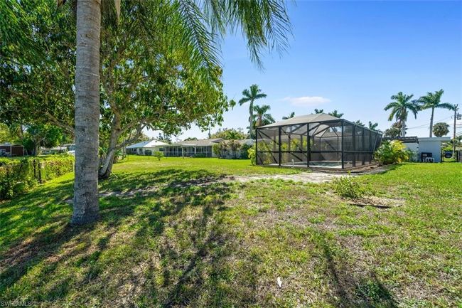 View of yard featuring an outdoor pool and glass enclosure | Image 20