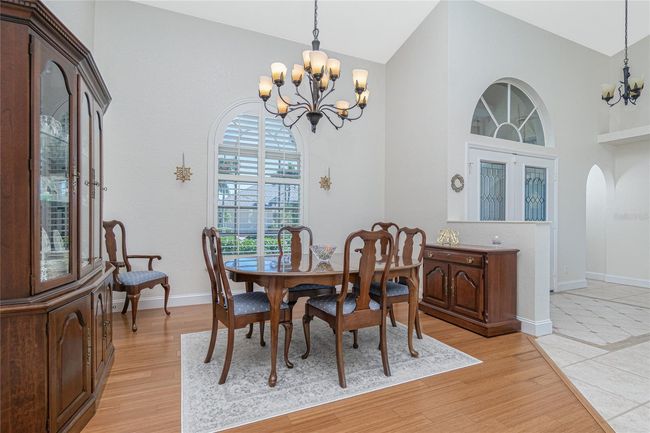 Dining room with bamboo flooring and plantation shutters | Image 9