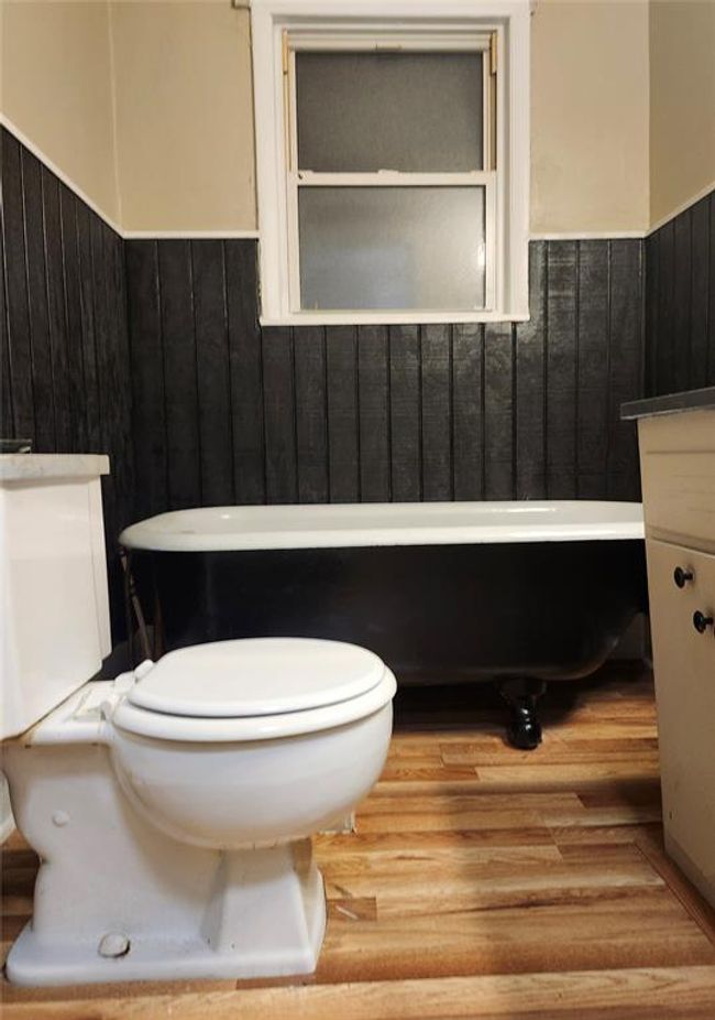 Bathroom featuring vanity, toilet, and hardwood / wood-style flooring | Image 5