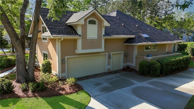 Garage has 2-vehicle door and a golf cart garage door. Seller has used it for a small car. The garage is oversized and has a storage closet under the bonus room stairs. There is also a parking spot for a car adjacent to the service yard. | Image 52