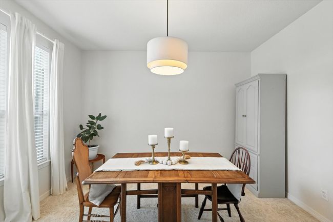 Dining space with light carpet and baseboards | Image 5
