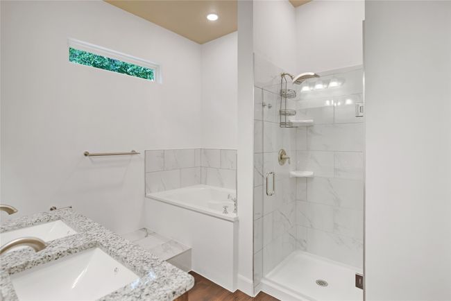Full bathroom featuring a garden tub, a stall shower, vanity, and wood finished floors | Image 16