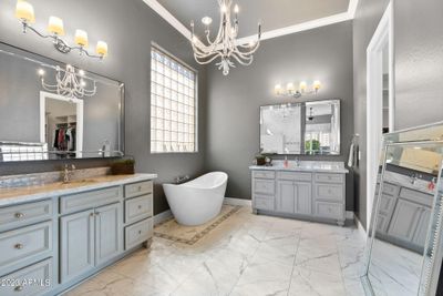 Updated Primary Bathroom Featuring Marble Countertops and Porcelain Tile! | Image 1