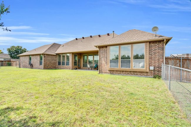 Rear view of house featuring brick siding and roof with shingles | Image 20
