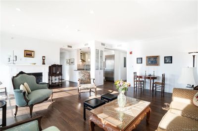 Living room featuring sink, crown molding, and dark hardwood / wood-style flooring | Image 3