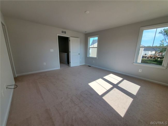 Empty room with dark carpet and a healthy amount of sunlight | Image 27