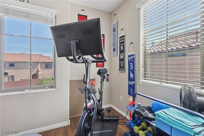 Workout area with wood finished floors and baseboards | Image 35