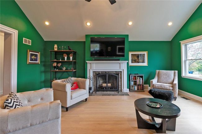 Living room featuring, wood burning fireplace, vaulted ceiling | Image 4