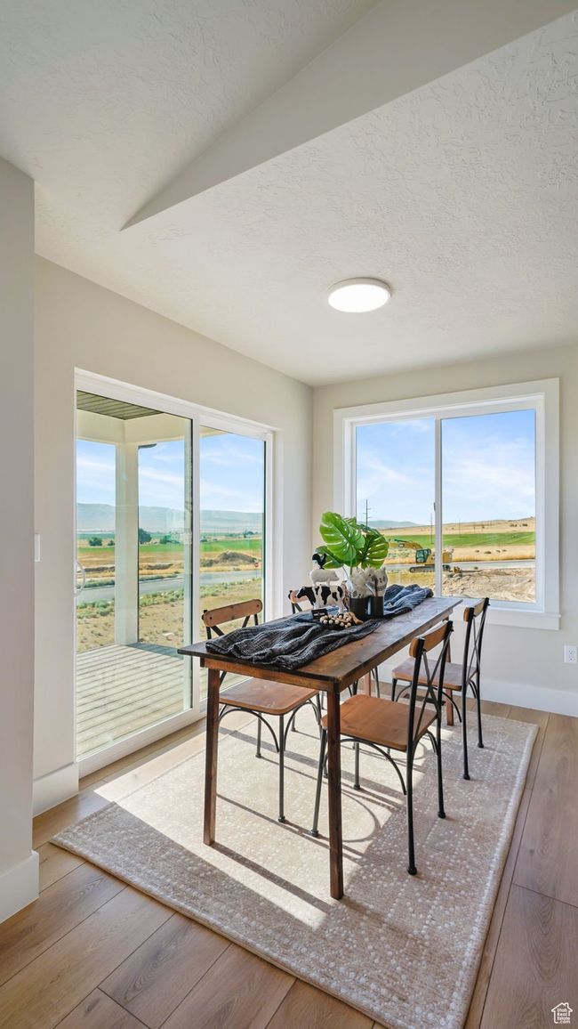 Dining area with baseboards and light wood-type flooring | Image 8