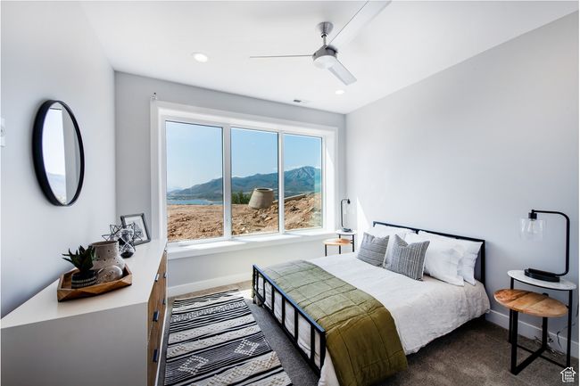 Carpeted bedroom with a mountain view and ceiling fan | Image 13