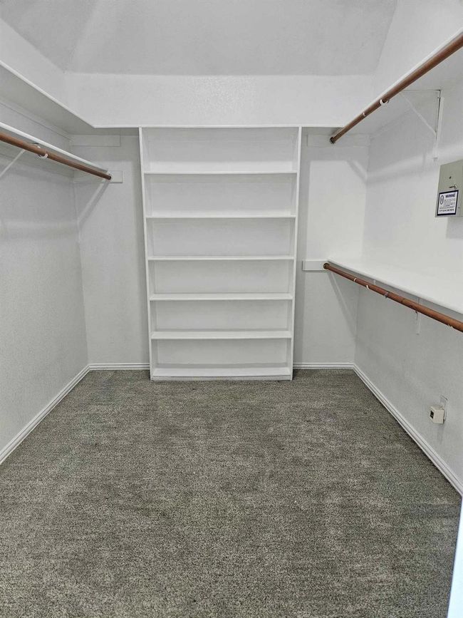 Spacious closet with carpet floors | Image 14