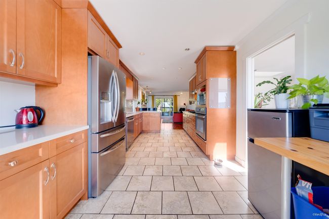 Kitchen featuring recessed lighting, light tile patterned flooring, and stainless steel appliances | Image 20