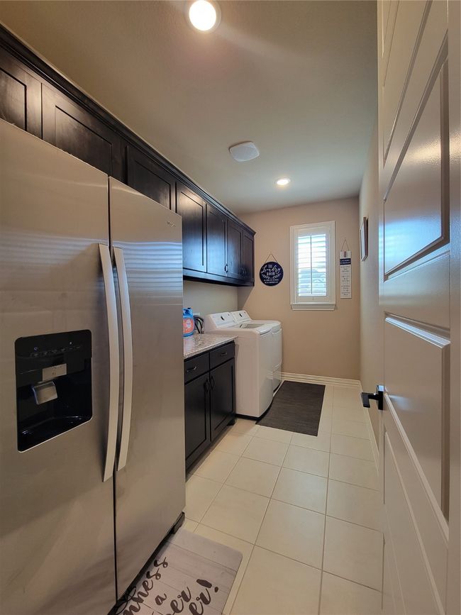 Washroom featuring washer and clothes dryer, light tile patterned flooring, and recessed lighting | Image 17